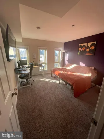 a bed room with a bed furniture and a tv