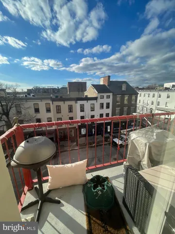 a roof deck with dining table and chairs