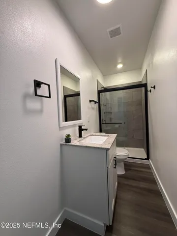 a bathroom with a sink a toilet and mirror