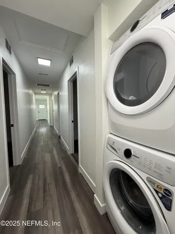 a view of a hallway with washer and dryer