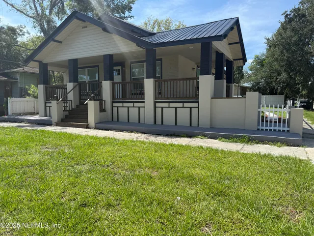 a view of a house with a yard and sitting area