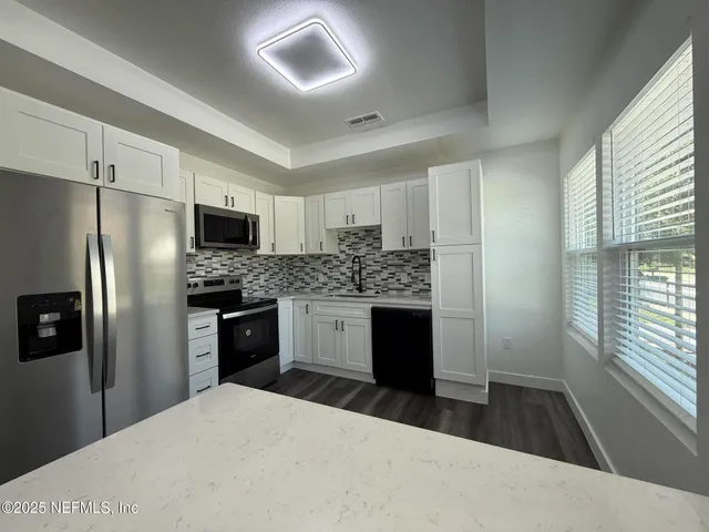 a kitchen with a refrigerator sink and stove