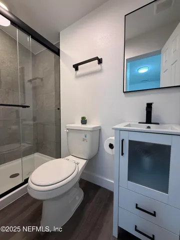 a bathroom with a toilet a sink and shower