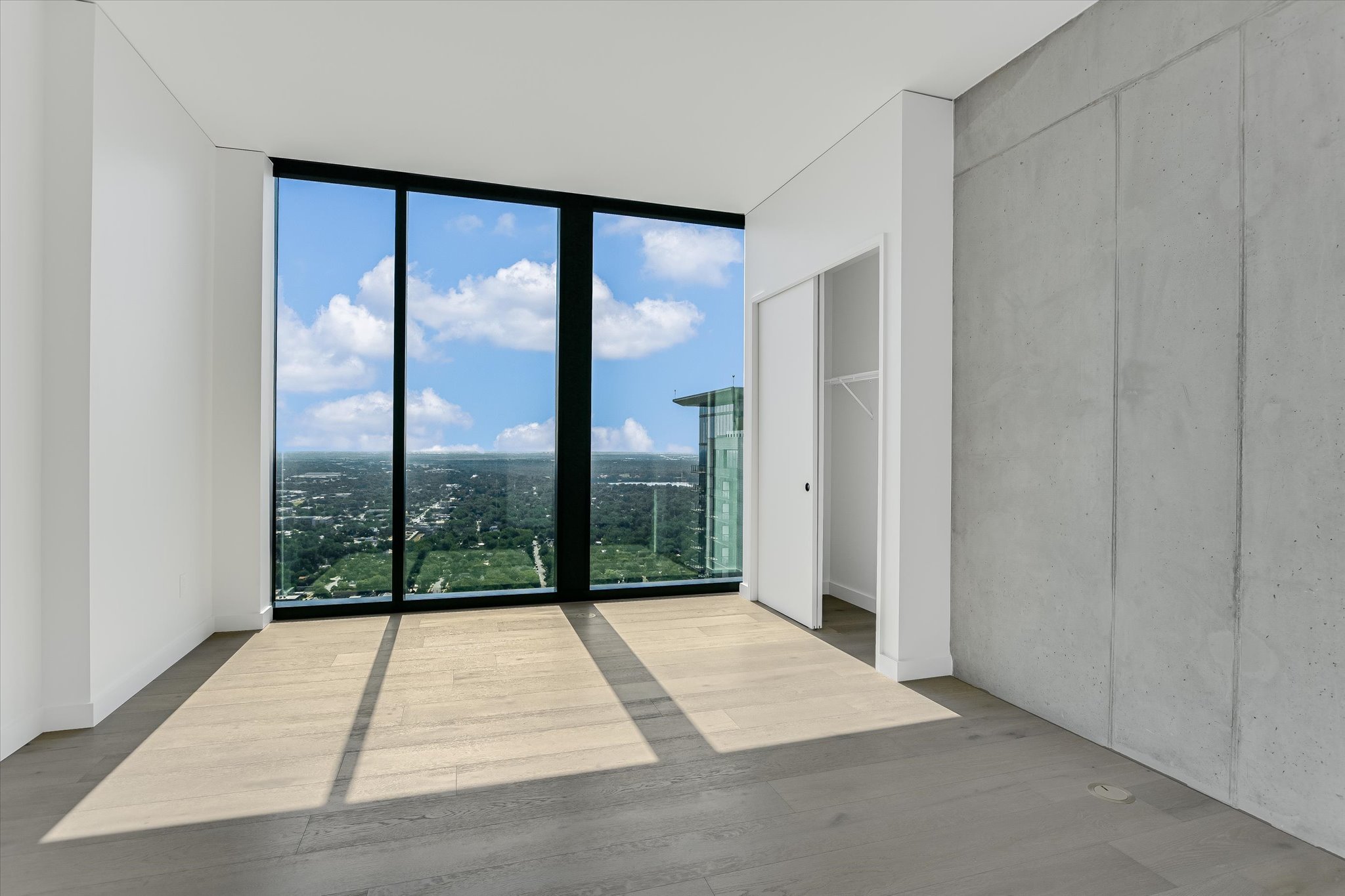 610 Davis Street, Unit 3801 Austin, TX 78701 - Photo 23 of 40 a view of empty room with wooden floor and windows