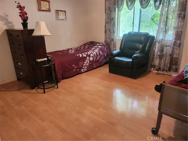 a bedroom with furniture and a window