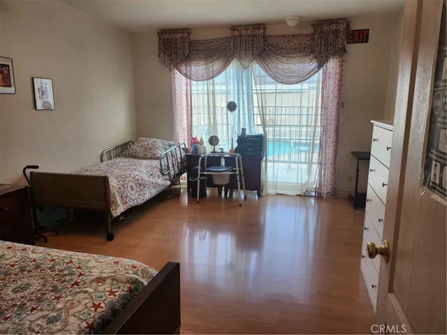 a bedroom with furniture and a wooden floor