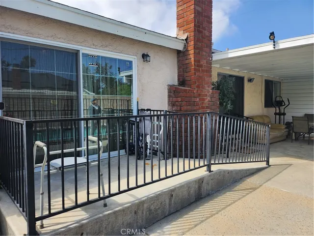 a view of a balcony with a floor to ceiling window and wooden fence