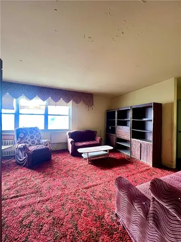 a bedroom with furniture and a window