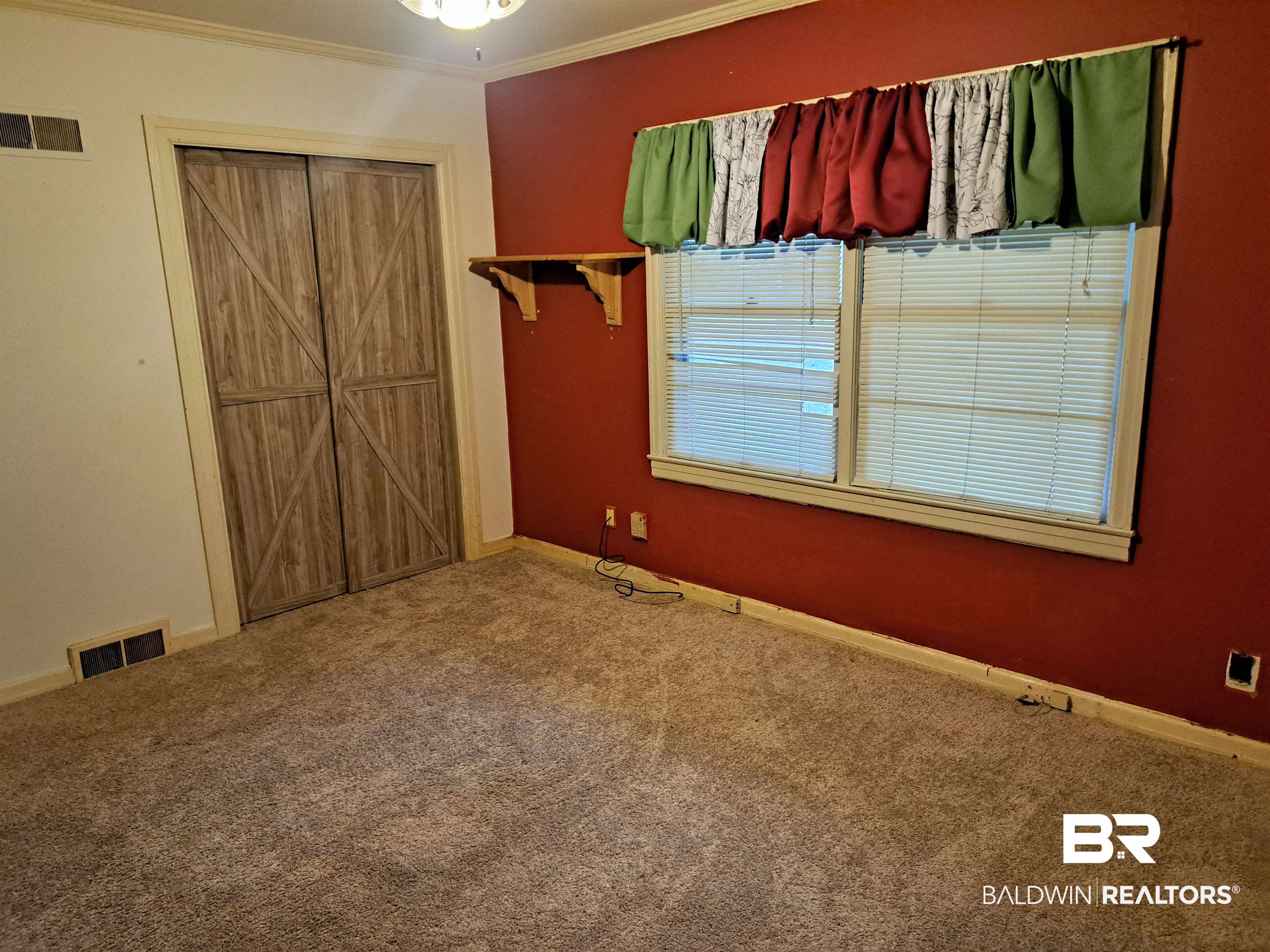 249 Newton Parkway Evergreen, AL 36401 - Photo 18 of 28 Unfurnished bedroom featuring ornamental molding, carpet floors, and a closet