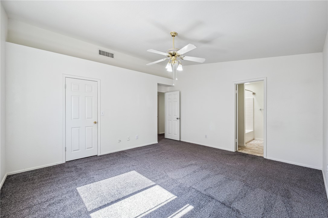 2524 South Ridge Avenue Bullhead City, AZ 86429 - Photo 29 of 64 Unfurnished bedroom featuring carpet flooring, baseboards, ensuite bathroom, and ceiling fan