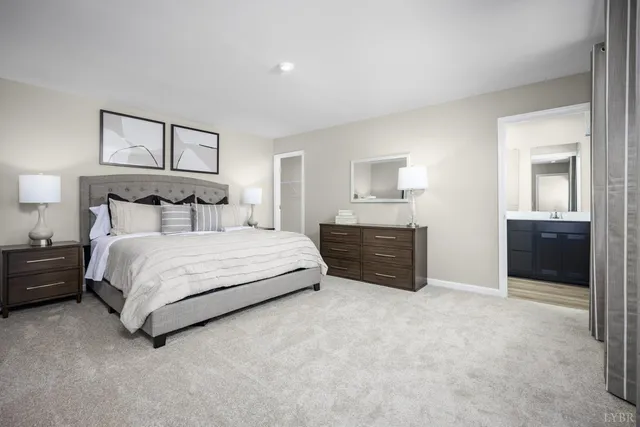 a spacious bedroom with a bed and a lamp