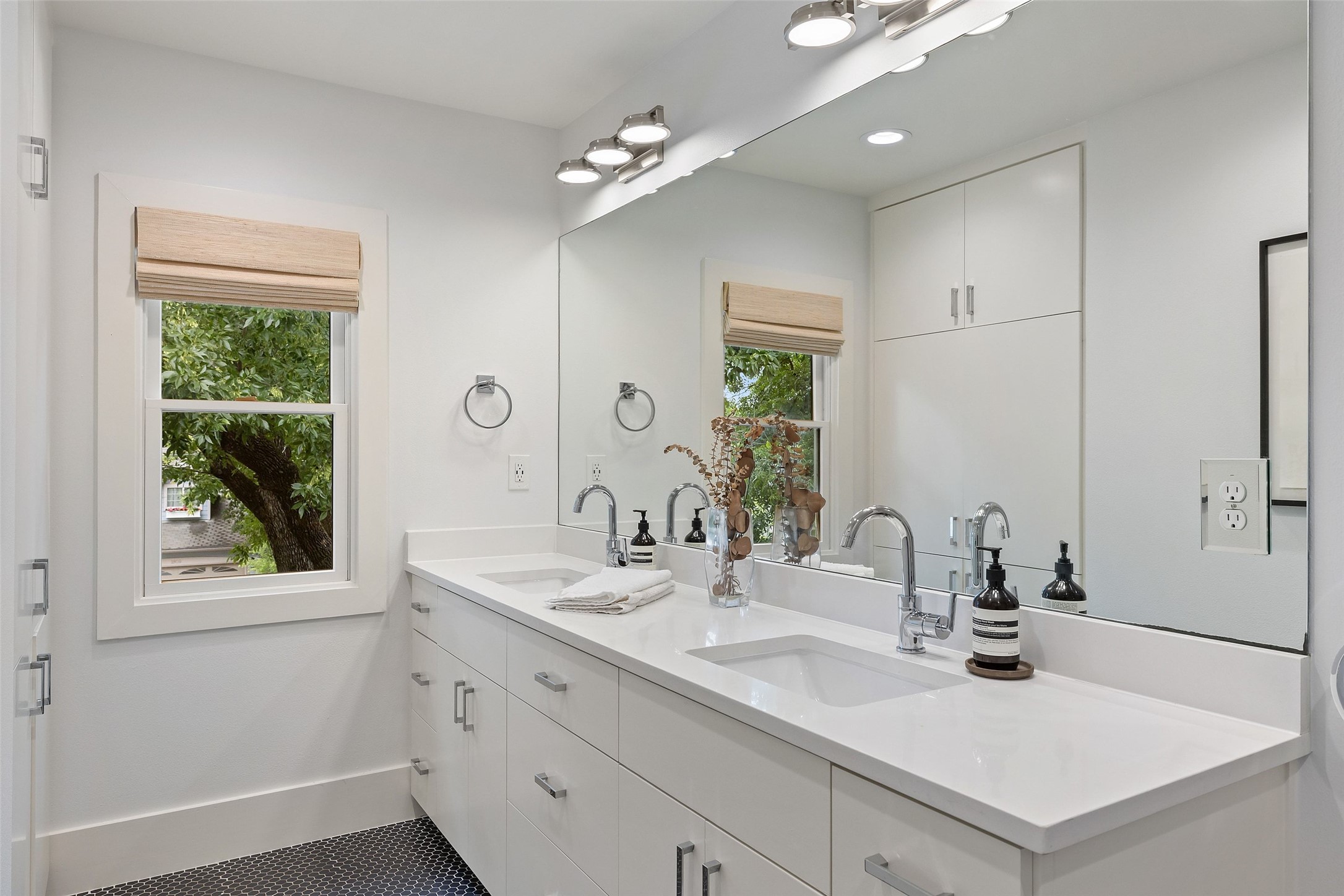 2000 Rundell Place Austin, TX 78704 - Photo 26 of 38 A well-lit primary bathroom vanity provides dual sinks and ample counter space.