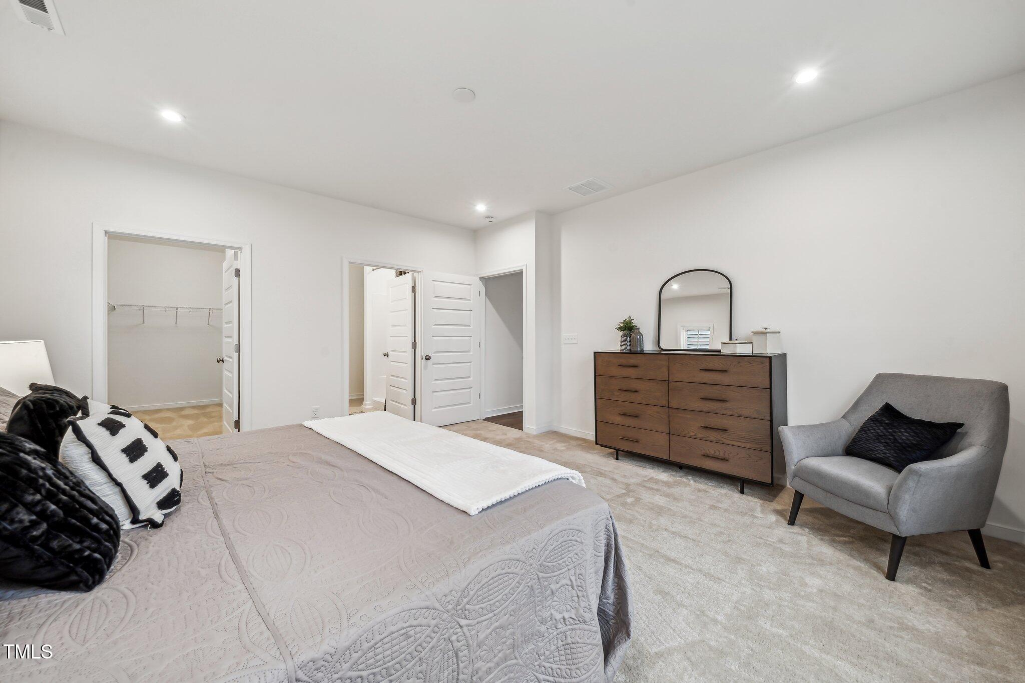 149 Cribbs Lane Middlesex, NC 27557 - Photo 15 of 33 a spacious bedroom with a bed a couch and dresser