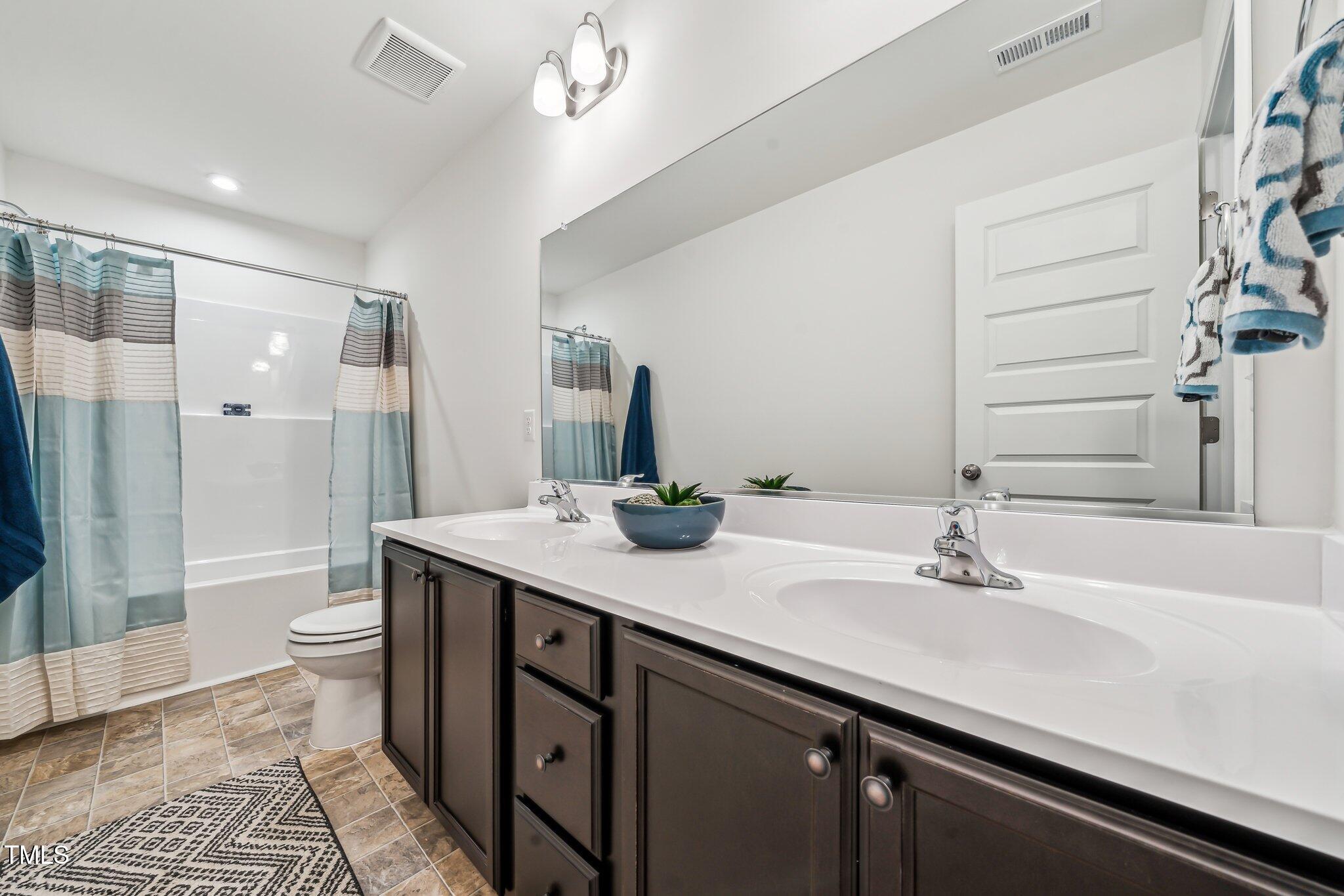 149 Cribbs Lane Middlesex, NC 27557 - Photo 24 of 33 a bathroom with a double vanity sink toilet and shower