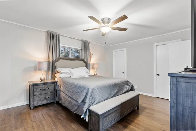 a bedroom with a bed and a chandelier