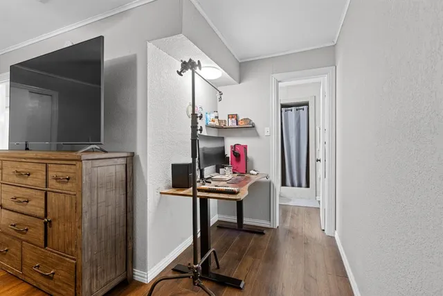 a view of a workspace with furniture and wooden floor