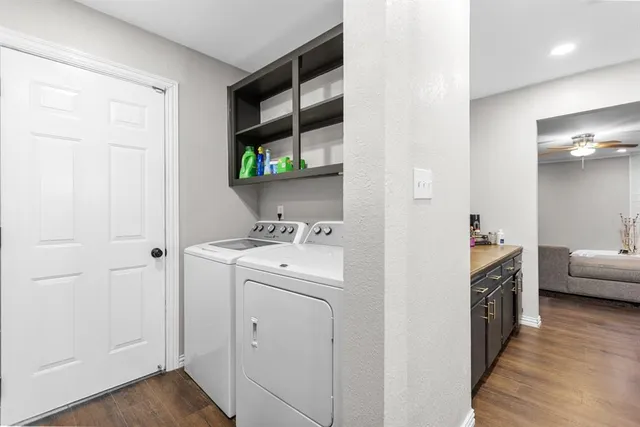 a kitchen with a sink and wooden floor