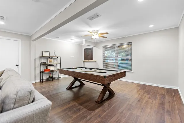 a living room with furniture a window and a flat screen tv