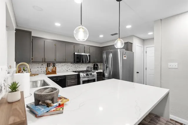 a kitchen with sink a stove and cabinets
