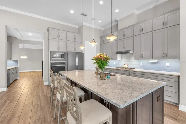 a kitchen with granite countertop a sink appliances counter top space and cabinets