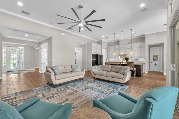 a living room with furniture and a view of kitchen