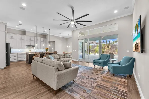 a living room with furniture and a wooden floor