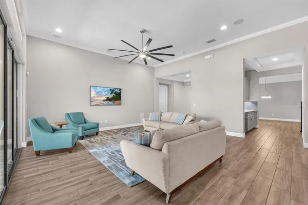 a dining room with furniture a chandelier and wooden floor