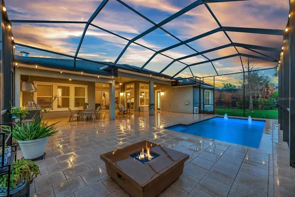 a backyard of a house with yard table and chairs