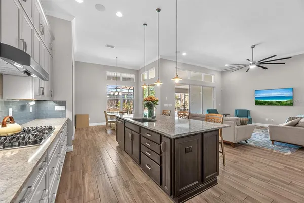 a kitchen with a sink cabinets and wooden floor
