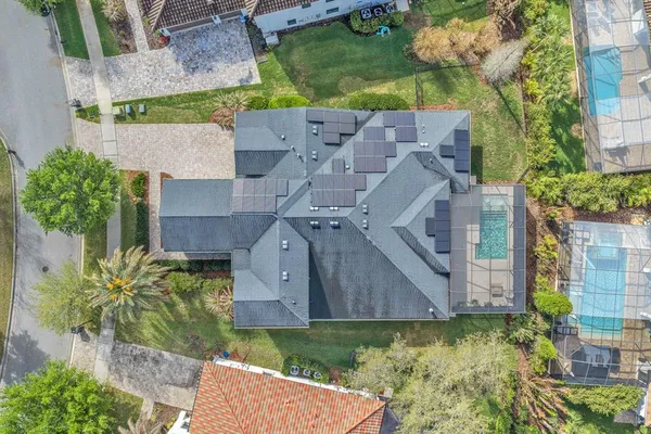 an aerial view of a house with a yard