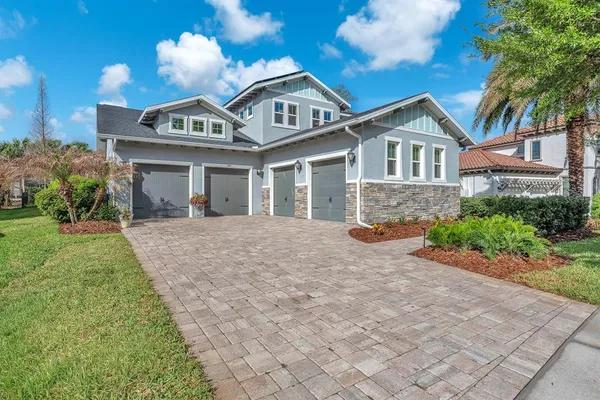 a front view of a house with yard and parking