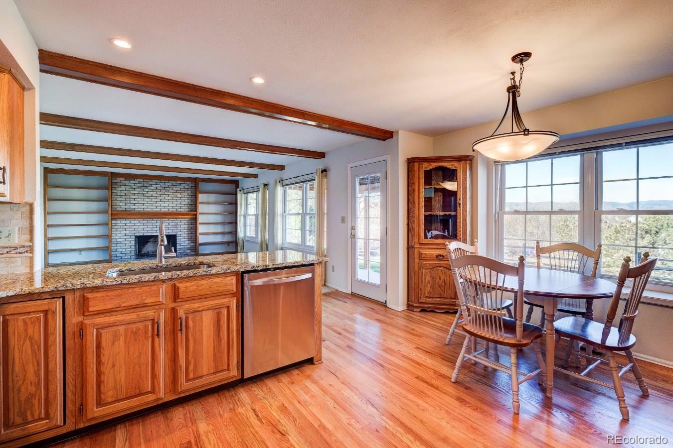 8927 Mountain Laurel Way Highlands Ranch, CO 80126 - Photo 12 of 35 a dining room with furniture window wooden floor