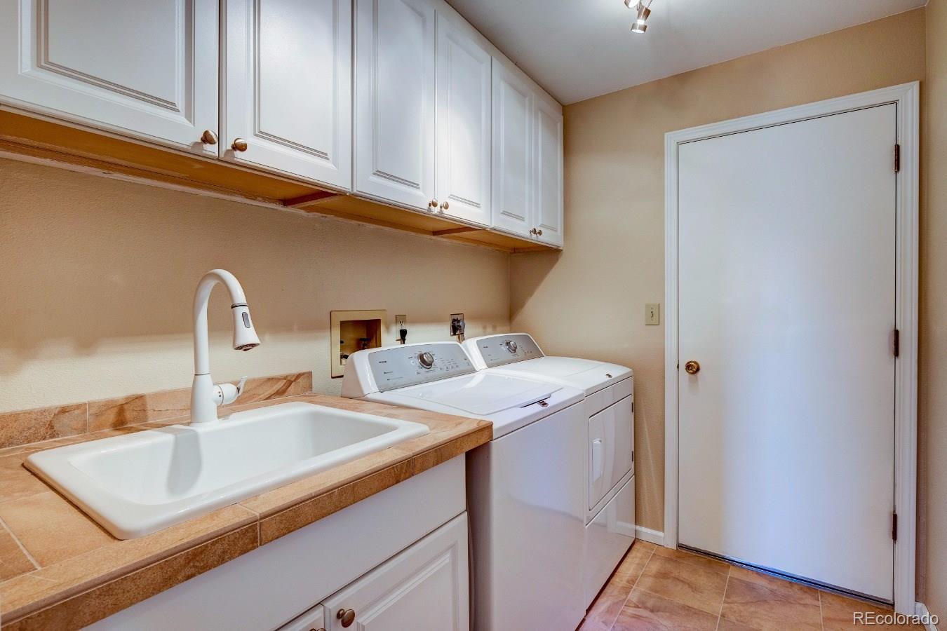 8927 Mountain Laurel Way Highlands Ranch, CO 80126 - Photo 17 of 35 a utility room with sink dryer and washer