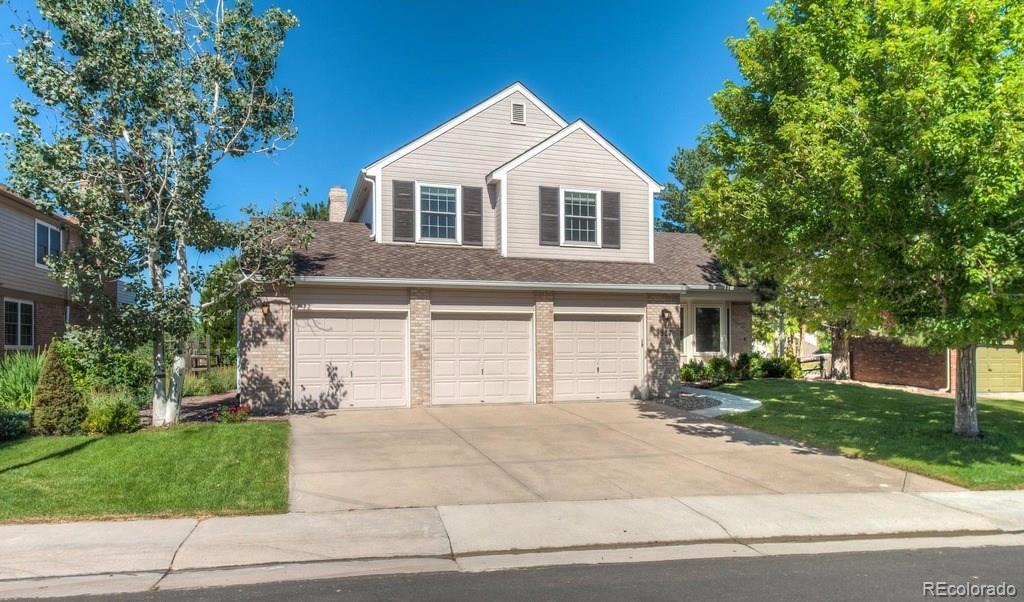 8927 Mountain Laurel Way Highlands Ranch, CO 80126 - Photo 2 of 35 a front view of a house with a yard and garage