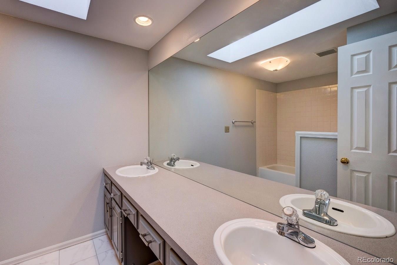 8927 Mountain Laurel Way Highlands Ranch, CO 80126 - Photo 26 of 35 a bathroom with a sink and a mirror