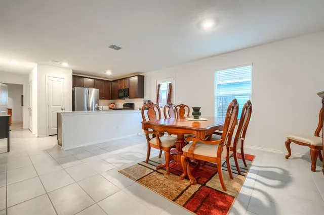 a view of a dining room with furniture and a kitchen