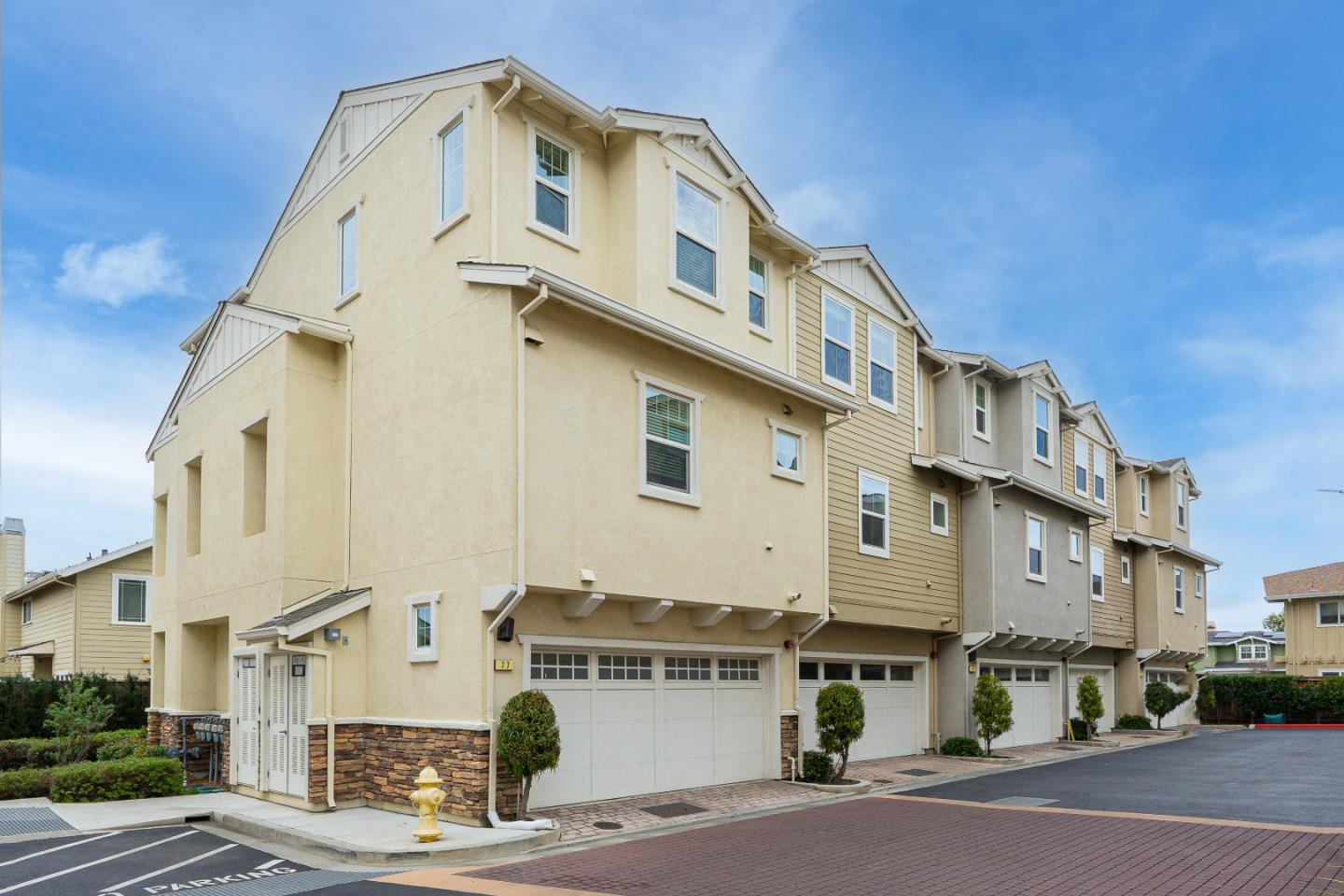 a front view of a building with parking