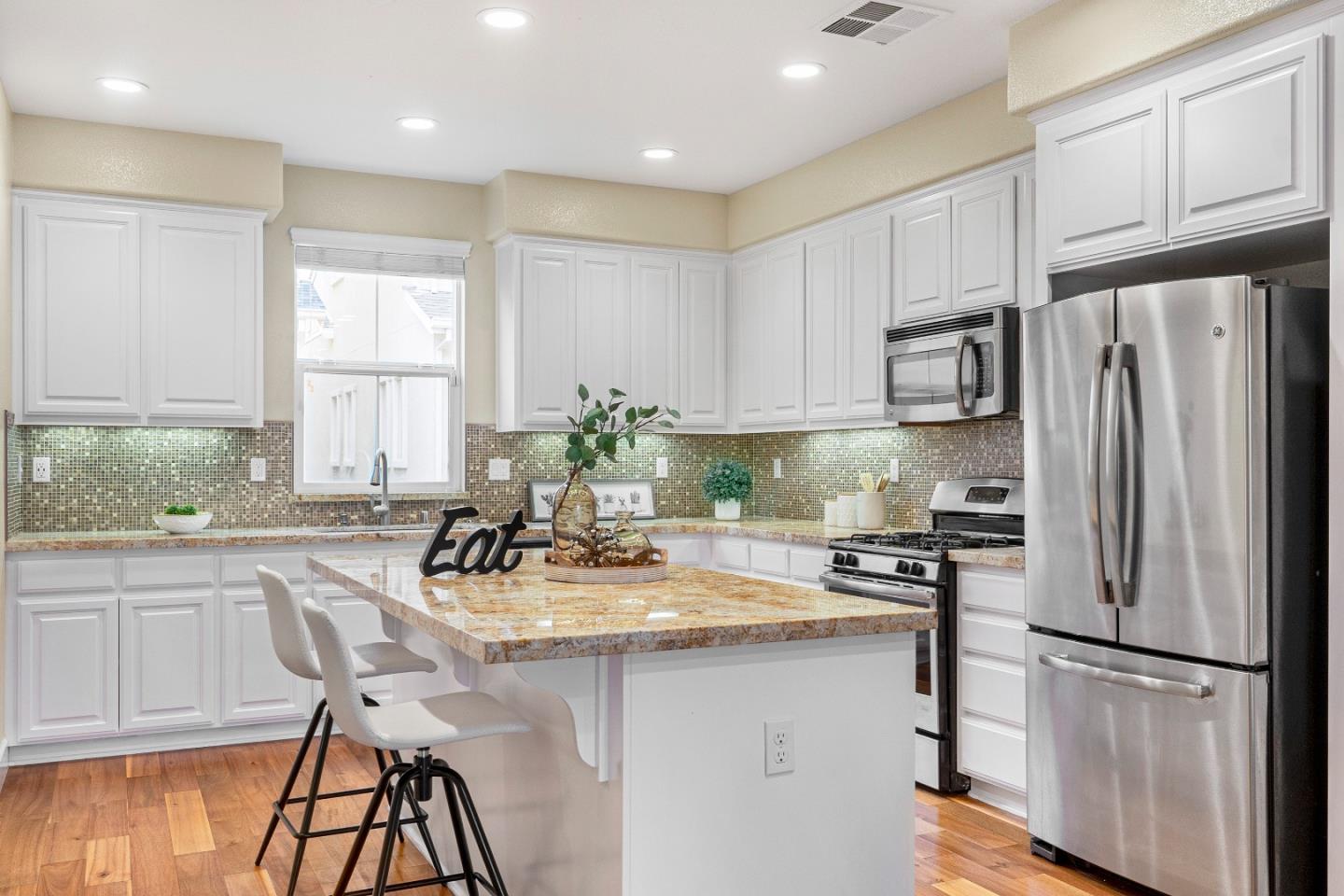79 Braxton Terrace Campbell, CA 95008 - Photo 11 of 36 a kitchen with refrigerator cabinets and chairs