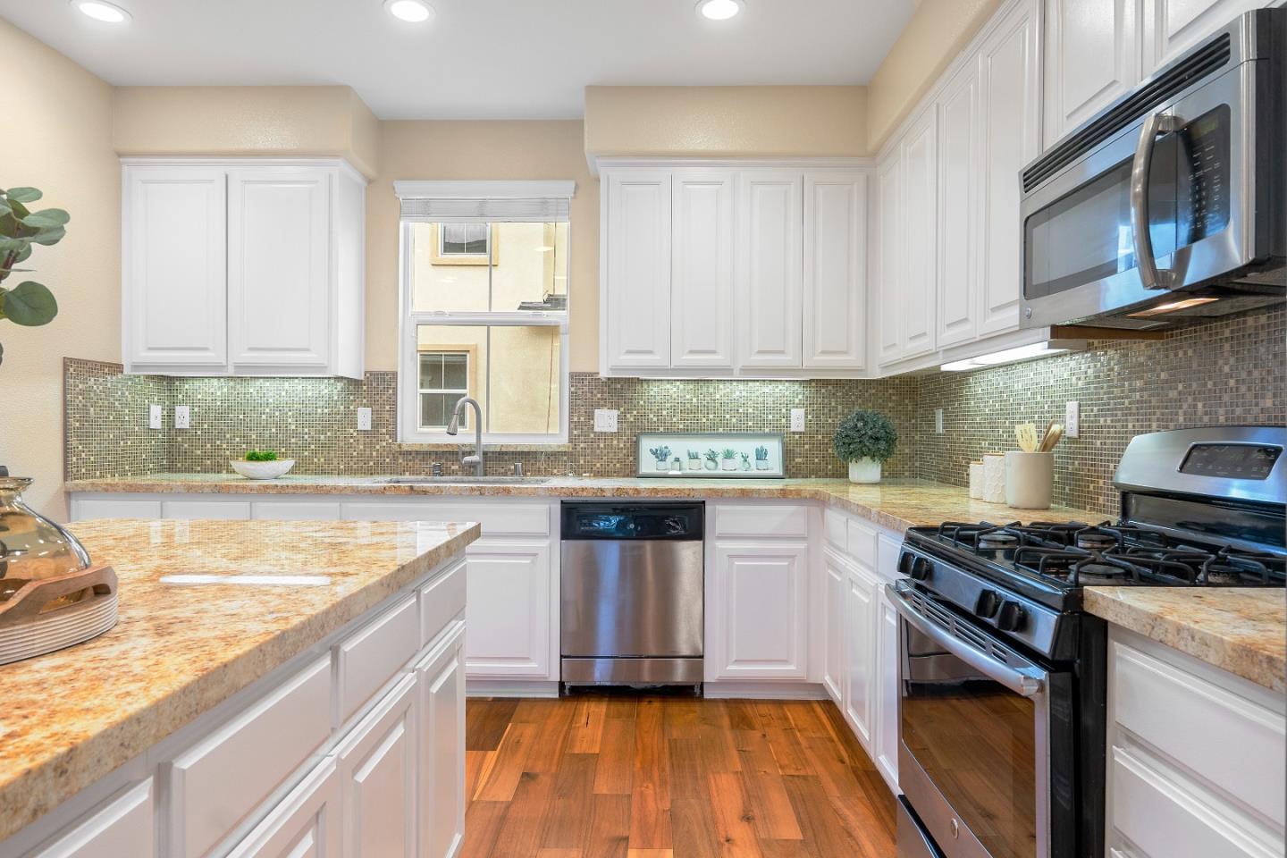 79 Braxton Terrace Campbell, CA 95008 - Photo 12 of 36 a kitchen with stainless steel appliances granite countertop a stove a sink and a microwave