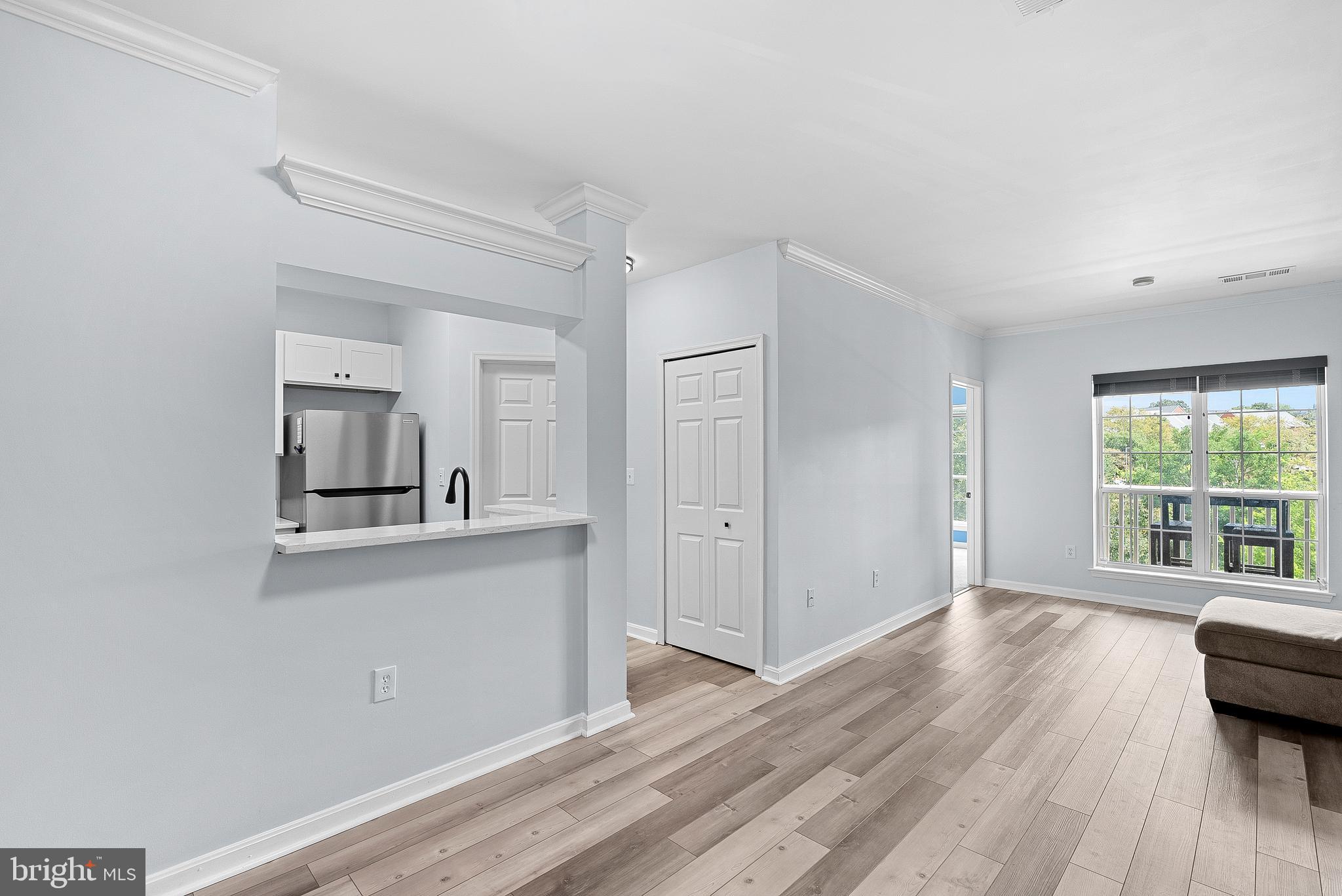 4551 Strutfield Lane, Unit 4111 Alexandria, VA 22311 - Photo 11 of 35 a living room with furniture and a wooden floor
