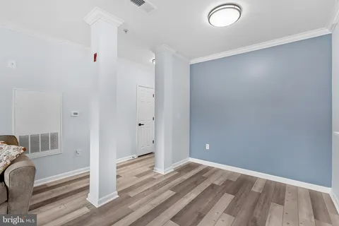 a view of empty room with wooden floor