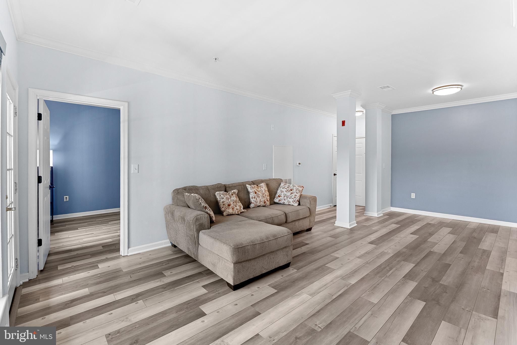 4551 Strutfield Lane, Unit 4111 Alexandria, VA 22311 - Photo 14 of 35 a living room with furniture and a wooden floor