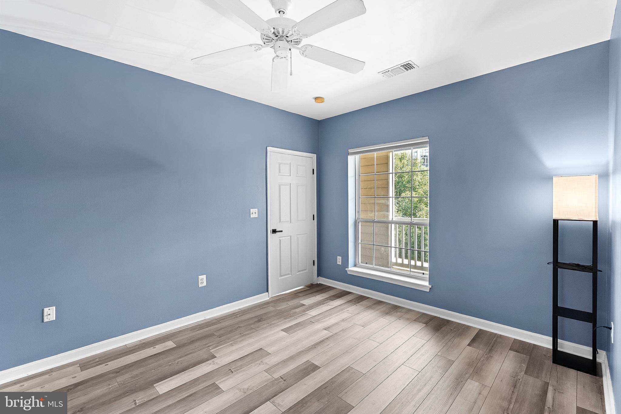 4551 Strutfield Lane, Unit 4111 Alexandria, VA 22311 - Photo 17 of 35 a view of an empty room with window and wooden floor