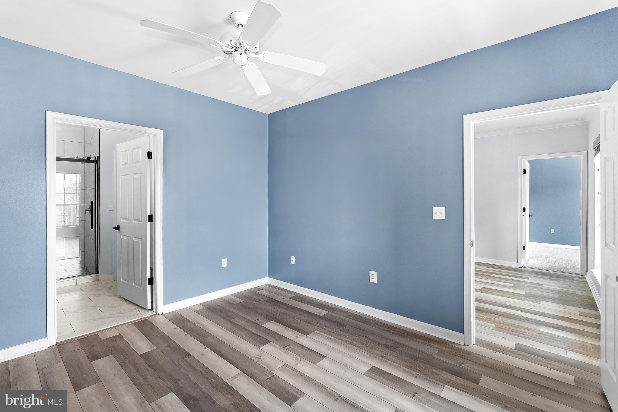4551 Strutfield Lane, Unit 4111 Alexandria, VA 22311 - Photo 18 of 35 a view of a livingroom with wooden floor and a ceiling fan