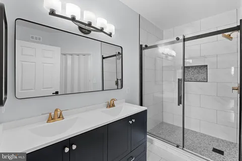 a bathroom with a shower sink and mirror