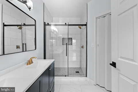 a bathroom with a shower sink and mirror