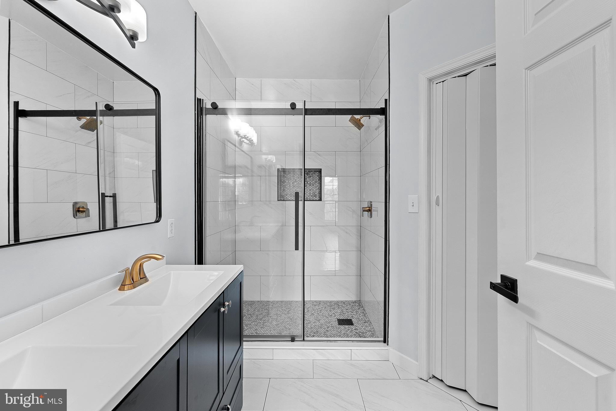 4551 Strutfield Lane, Unit 4111 Alexandria, VA 22311 - Photo 20 of 35 a bathroom with a shower sink and mirror