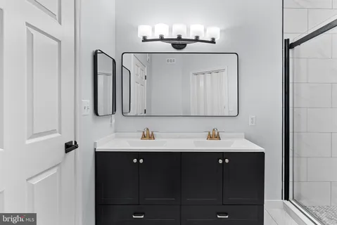 a bathroom with a sink vanity and mirror