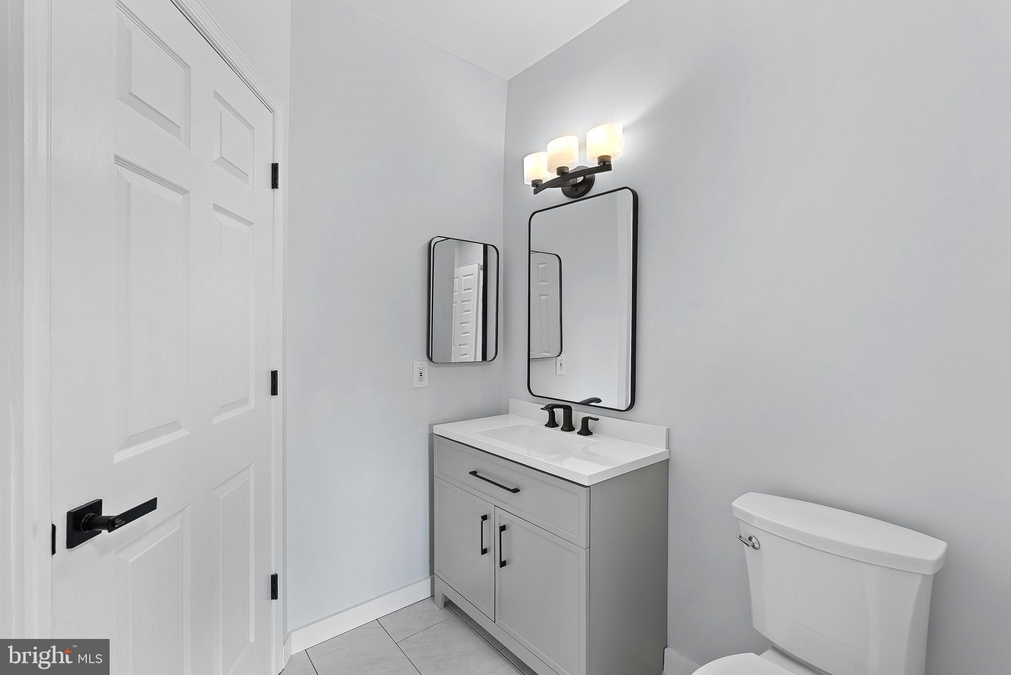 4551 Strutfield Lane, Unit 4111 Alexandria, VA 22311 - Photo 25 of 35 a bathroom with a toilet sink and mirror