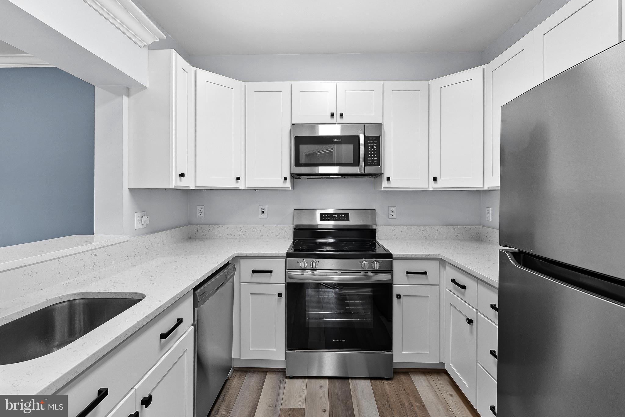 4551 Strutfield Lane, Unit 4111 Alexandria, VA 22311 - Photo 3 of 35 a kitchen with cabinets appliances and a sink